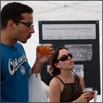 Two visitors looking at a photo exhibit during the campaign tea event 