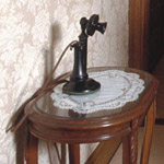 Historic phone on a phone table in the front hall of the house