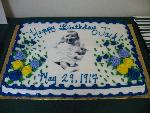 A birthcay cake with JFK baby picture