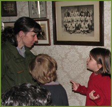 A ranger and student talk in the hallway of the JFK birthplace house.
