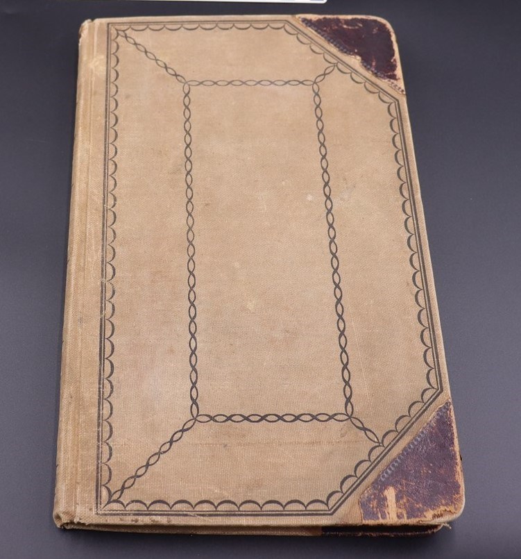 The outside cover of 19th century tan ledger that was used as a morgue book from 1889.
