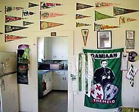 Multiple travel pennants on a wall in Kenjo's home.