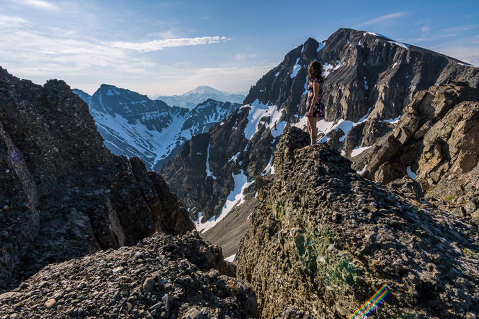 Woman standing on a rugged mountain ridge