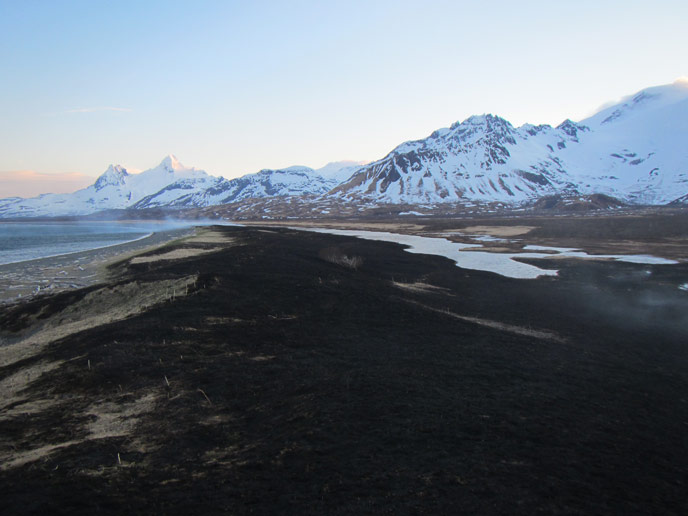 snowy mountains, brown plain and scorched area