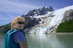 Kayaker by a glacier in Kenai Fjords