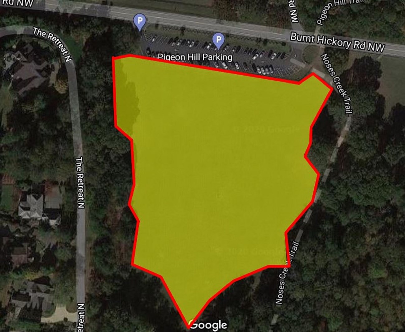Yellow highlights field area surrounded on 3 sides by trees. The top side is labeled Pigeon Hill Parking then a parallel road named Burnt Hickory Rd NW.