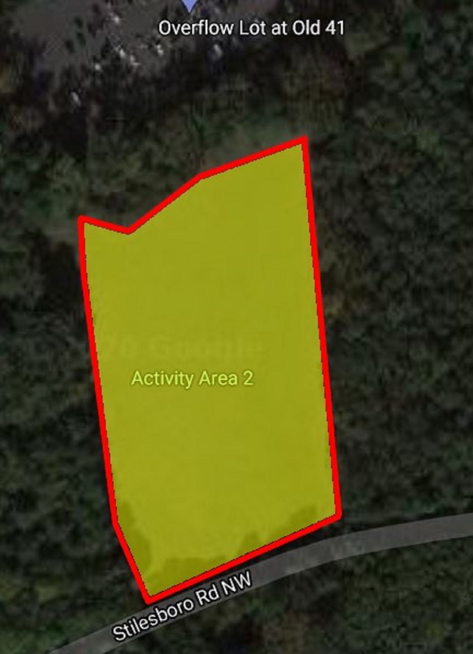 Yellow highlights rectangular area surrounded by trees. Top of picture is labeled Overflow Lot at Old 41. Below and adjacent to rectangular is parallel street labeled Stilesboro Rd NW.