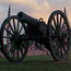 Sept. 11 tribute, field of flags with cannon under a sunset.