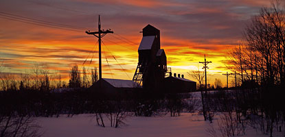 The abandoned shaft-rockhouse of the # 13 Osceola mine is silhouetted by a winter sunrise.