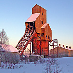 The last rays of winter's twilight illuminates the shafthouse of the Osceola #13 Mine. NPS Photo, Dan Johnson.