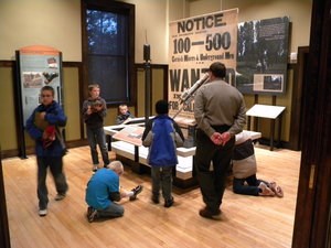 A ranger assists students exploring exhibits inside the Calumet Visitor Center.