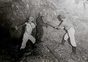 Historic photo: This 1875 photograph shows a team of three miners drills holes in the rock by hand.