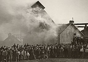 Historic photo: Smoke billows out of the Osceola #3 shaft while workers and area residents pose for this 1895 photograph.