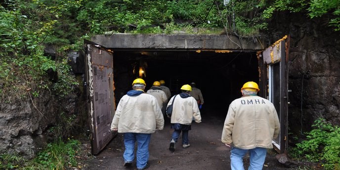 Visitors with hard hats enter the Quincy Mine, one of the Keweenaw Heritage Sites.