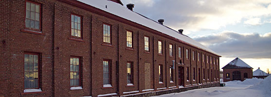 Windows in the the former Calumet & Hecla warehouse, reflect the last rays of the winter sun.