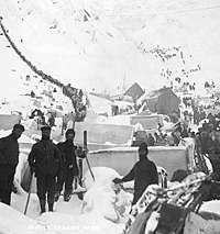 This image was cropped from a black and white historic photograph titled "Supply caches, freight and Klondikers at "The Scales, base of Chilkoot Pass, Alaska, 1898. " from University of Washington's Eric A. Hegg Collection.