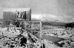 Black and white photo of collapsed wood building
