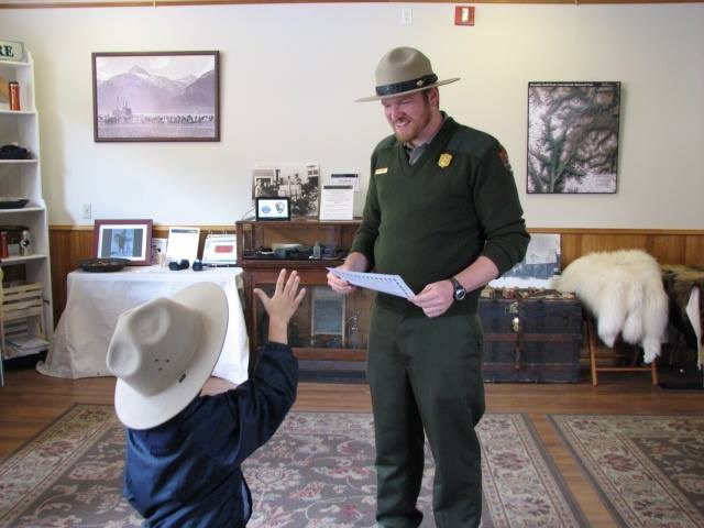 A ranger works with a child in the Junior Ranger Activity Center