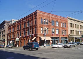 large, brick three story building on busy corner in Pioneer Square, Seattle