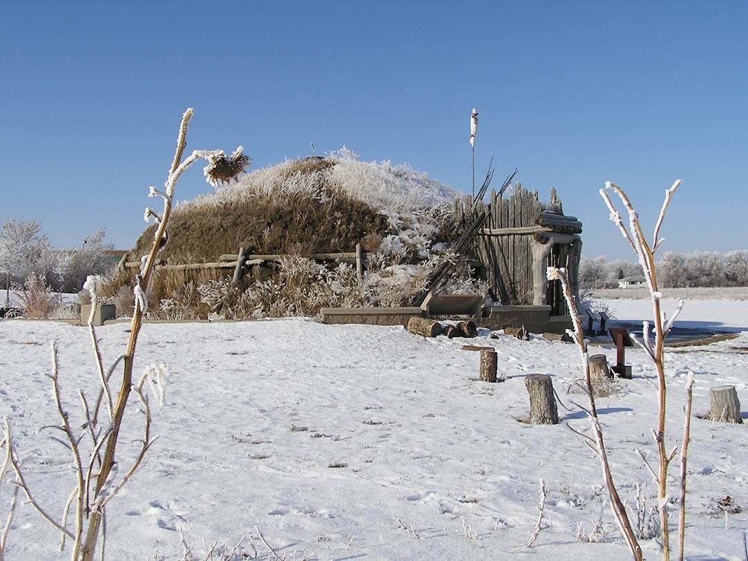 An earthlodge in the snow during winter.