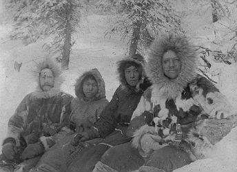 black and white photo of four men in parkas