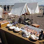 Re-enactors drill behind tents and a table of medical equipment dating from the 1872-73 Modoc War.