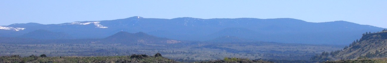 A long, low, forested hill viewed from a distance
