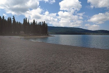 Medicine Lake beachfront with blue skys and clear water.