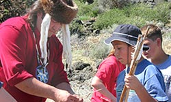Native American hunting skills being taught to young visitors
