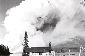 In this photo Babe and Mary Alsworth's home is shown in the foreground with the smoke from the 1953 fire billowing in the background.
