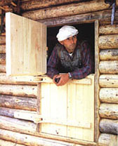 Richard Proenneke demonstrates the Dutch door at his Twin Lakes cabin.