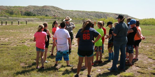Class discussing their field trip activity with a ranger.