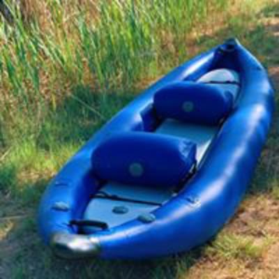 Blue ocean kayak ready for visitors...sitting in the green grasses in the wetlands.