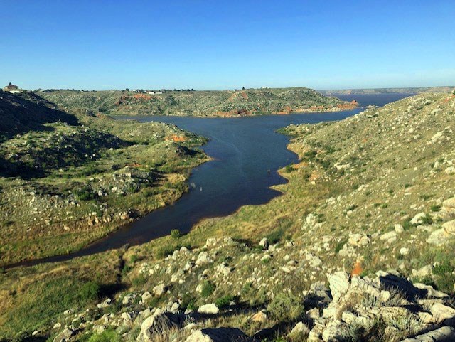 View of Lake Meredith from Fritch Fortress on a sunny day.  The blue lake is flowing into a cove.
