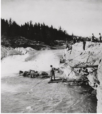 Man fishing on plank at Kettle Falls for fish