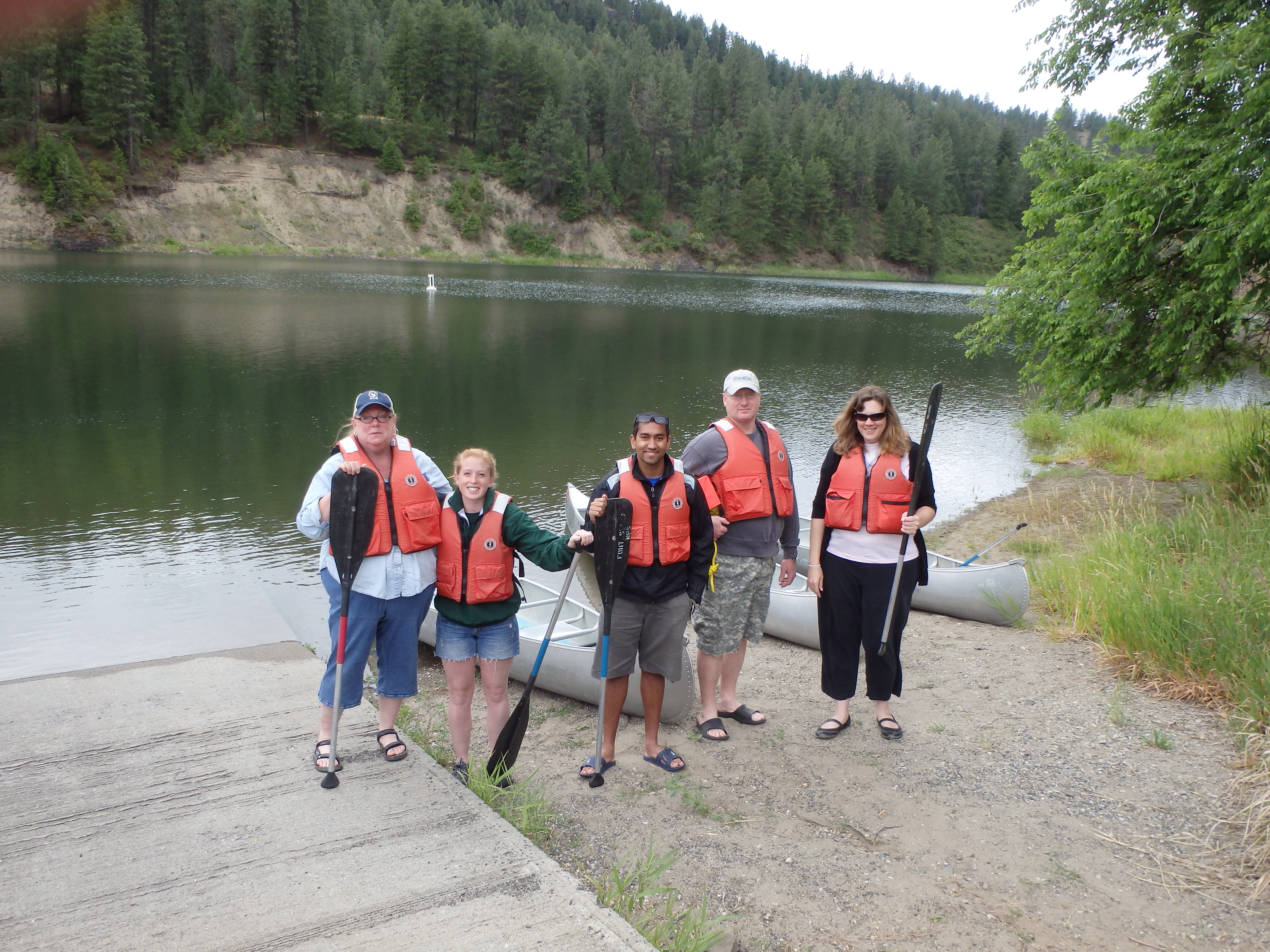 Five adults ready to go canoeing