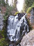 large waterfall in narrow canyon