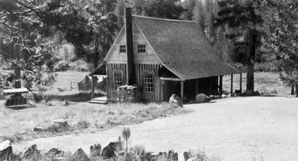 black and white photo of rustic cabin in 1931