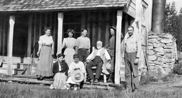 1910--Standing on porch L-R  Ida May, Pearl, and Roy.  Alex at far right black and white photo