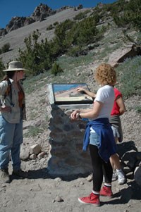 Hikers read an interpretive panel on the Lassen Peak Trail