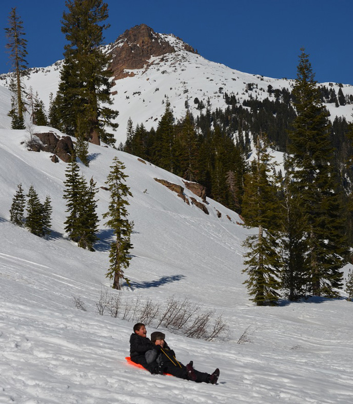 Kids sled on a hill behind the Kohm Yah-mah-nee Visitor Center.