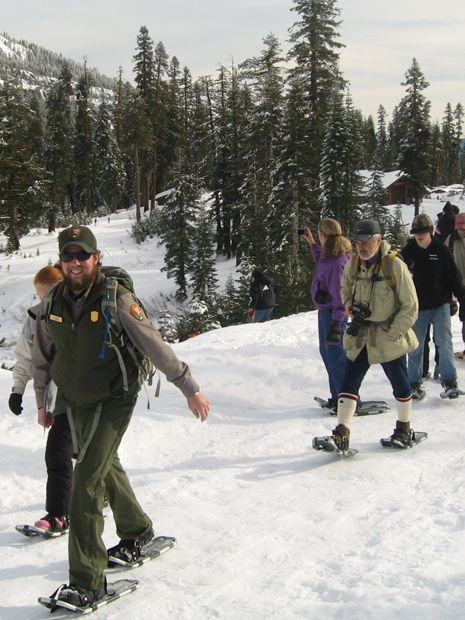 Ranger leads group on snowshoes from Kohm Yah-mah-nee Visitor Center.