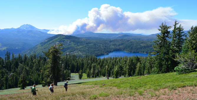Hikers view smoke from a wildland fire