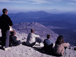 kids looking out over lassen peak after hiking to the top