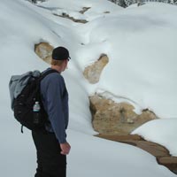 A snowshoer enjoys a view of Sulphur Works from a safe distance.