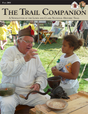 Fall 2011 Trail Companion cover image of interpreter dressed as if member of 1804 expedition talking to young girl