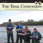 volunteers participating in sturgeon survey on Missouri River holding sturgeon and posing