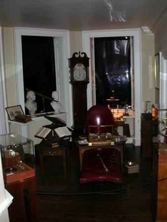 Cabinet room at Monticello with red leather chair, writing table, books and grandfather clock.