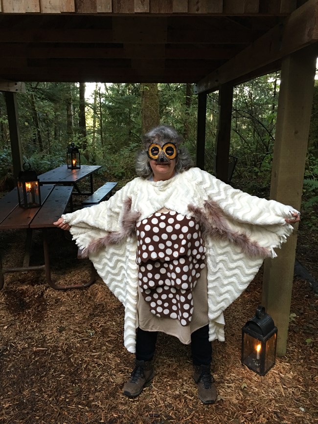 A woman dress in an owl costume.