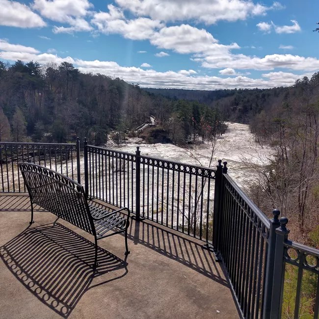 A bench located on the Highway 35 Bridge Walkway that overlooks Little River.